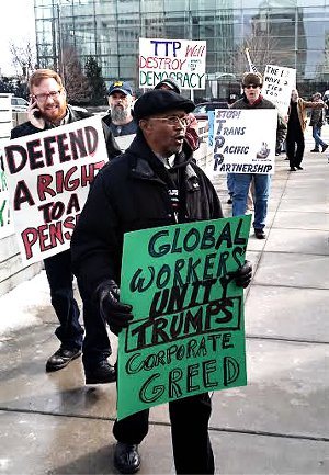 Autoworkers protest outside of the North American International Auto Show